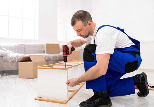 Loaders carrying furniture in the stairway